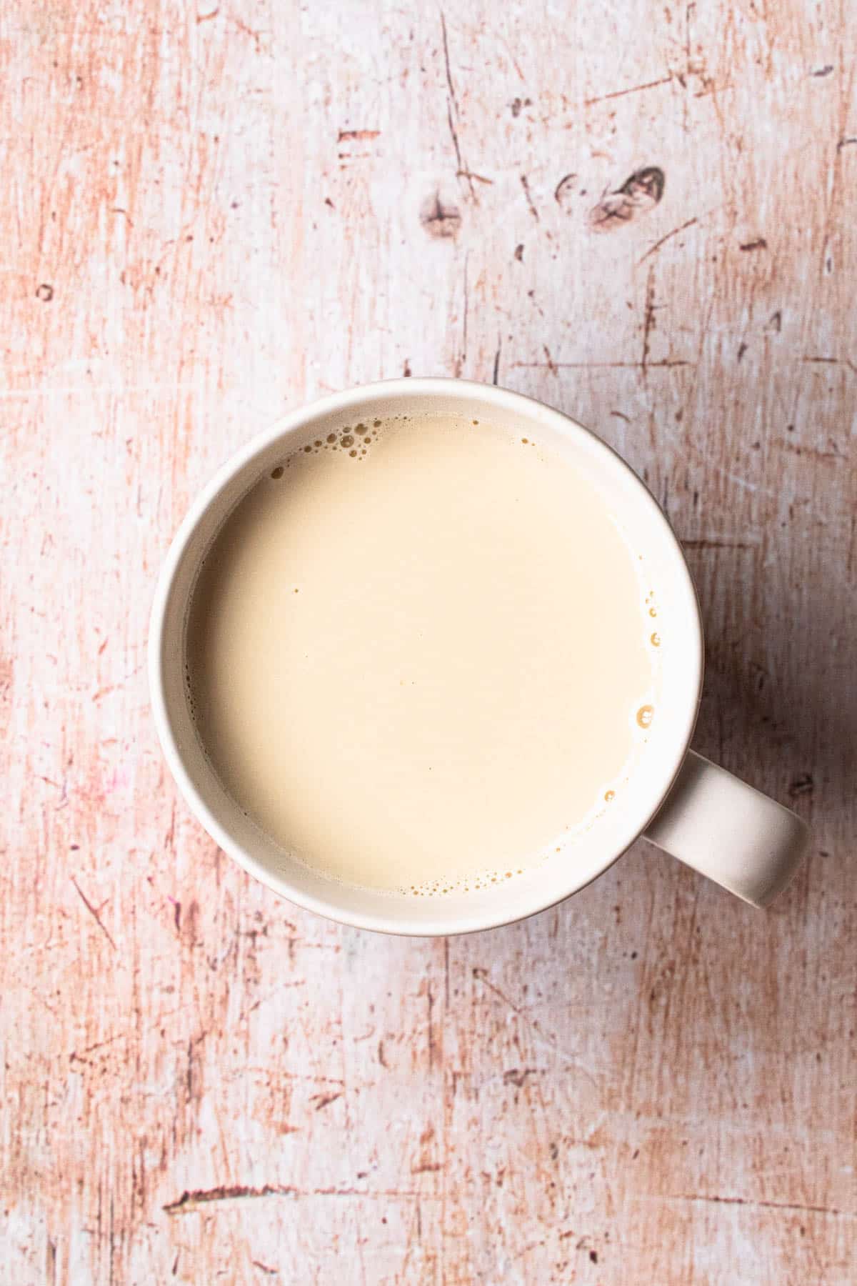 Strained chamomile milk tea in a mug.
