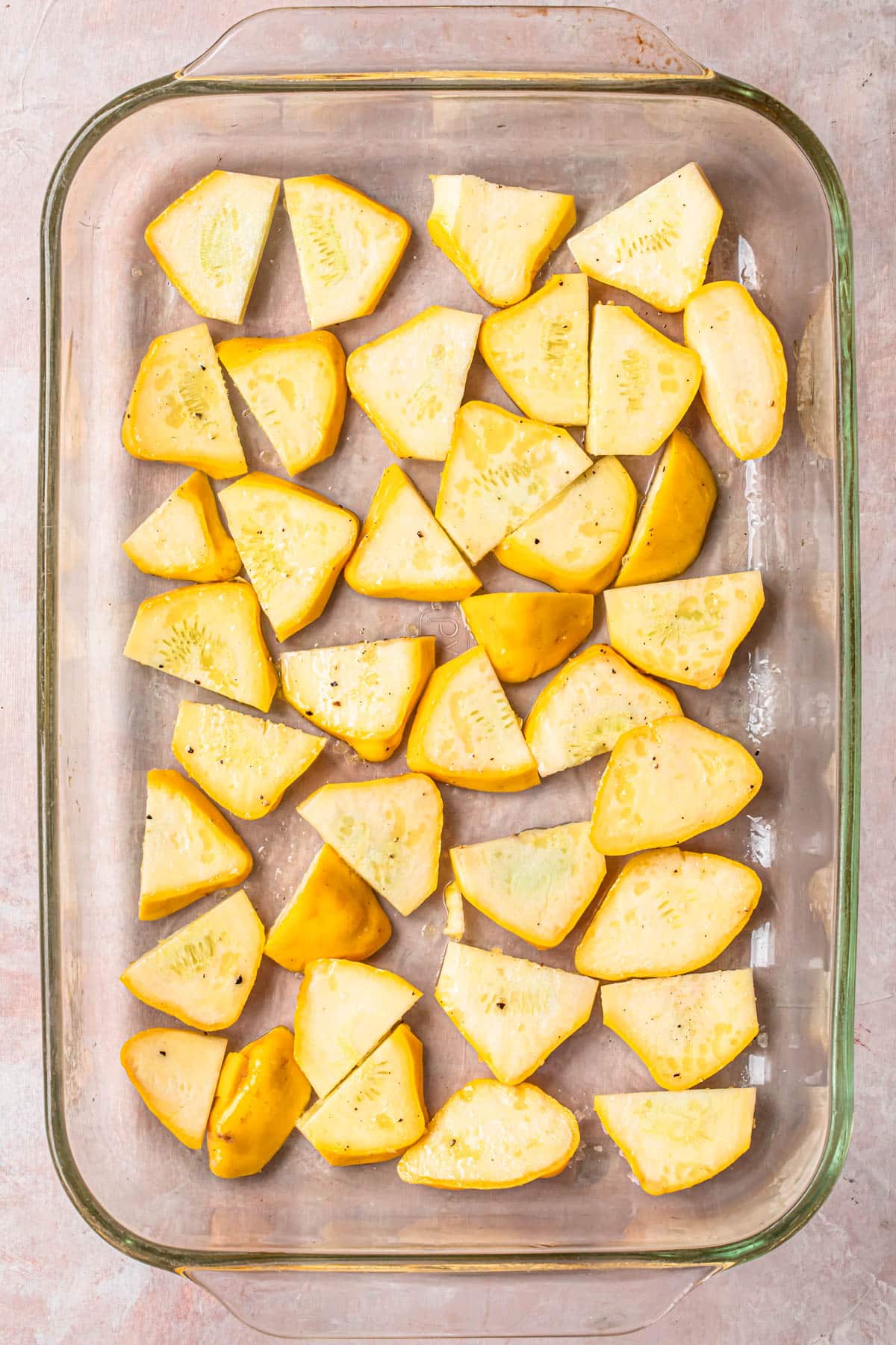 Thinly sliced yellow squash, tossed in olive oil, salt and pepper and spread out across the base of a glass baking dish.