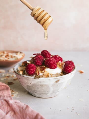 honey dripping over bowl of steel cut oats