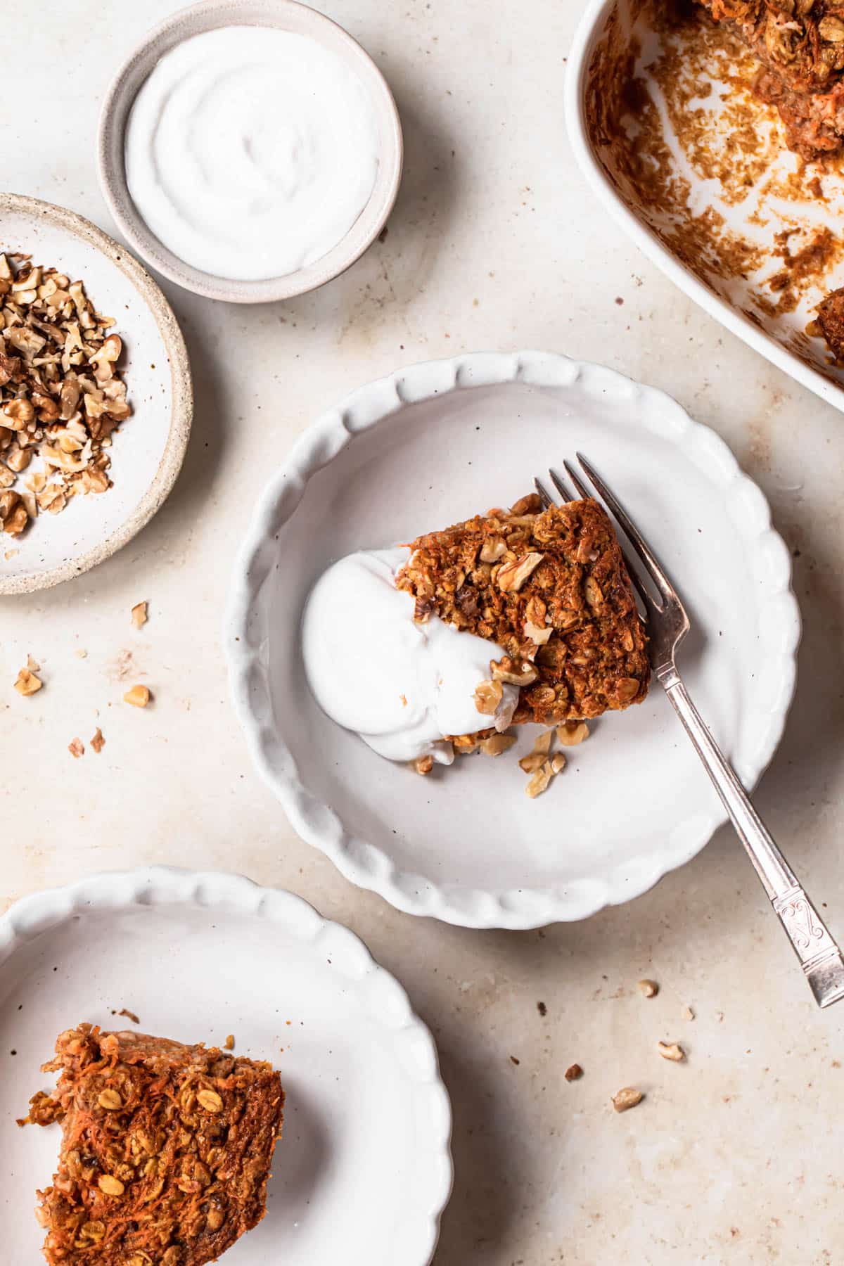 Carrot cake baked oats served topped with coconut yoghurt and walnuts.