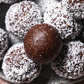 Nut free chocolate bliss balls on a plate.
