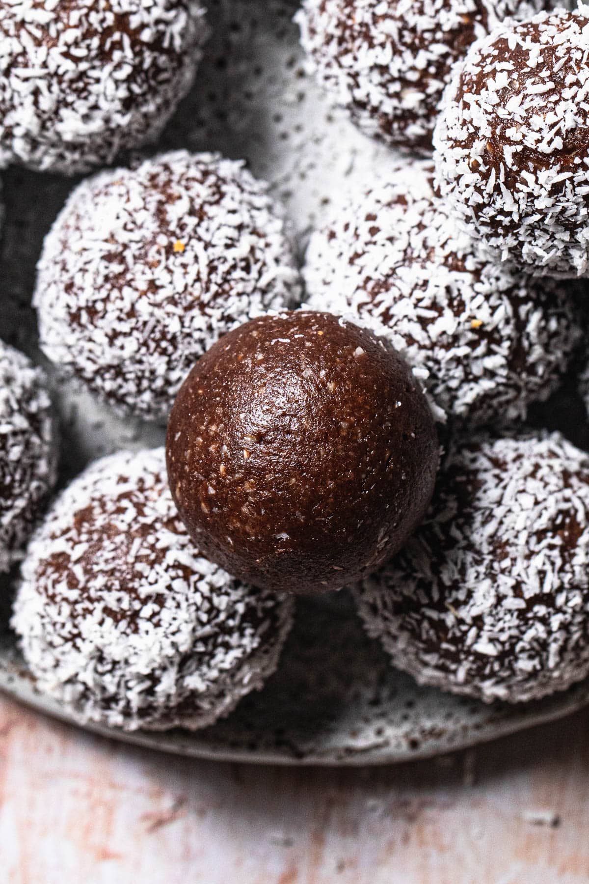 Nut free chocolate bliss balls on a plate.