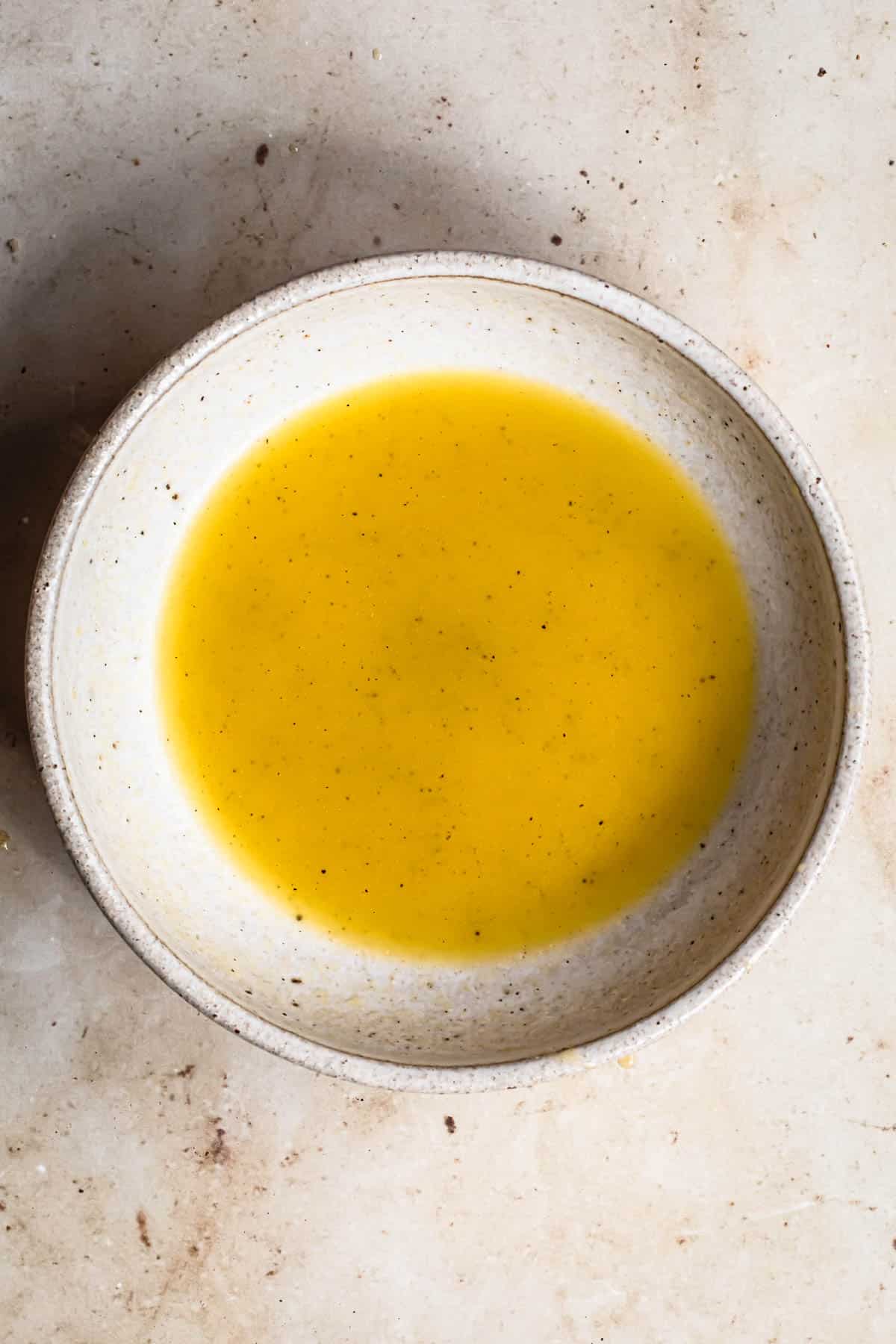 Lemon vinaigrette in a small bowl.