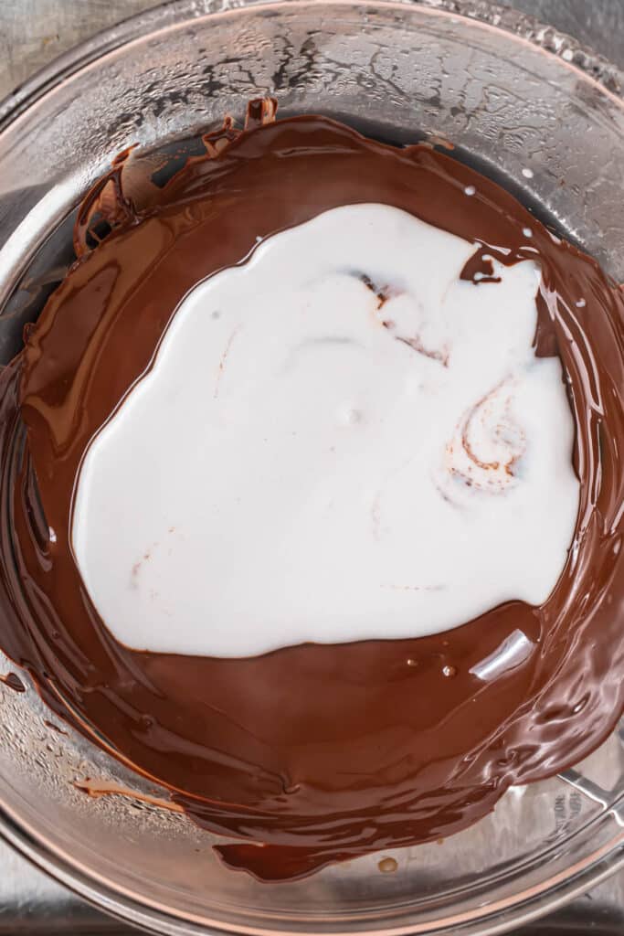 Coconut milk added to melted dark chocolate.