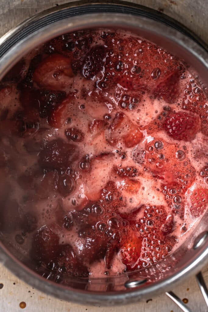 Strawberries stewing in a saucepan.