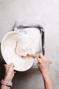 Pour marshmallow fluff into baking paper lined tray
