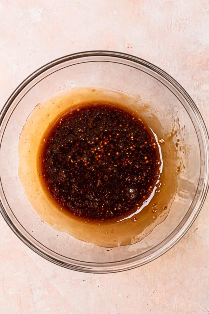 Balsamic salad dressing mixed together in a small glass mixing bowl.