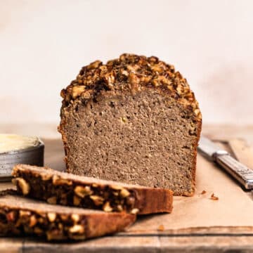 Baked buckwheat flour banana bread on wooden chopping board, sliced.