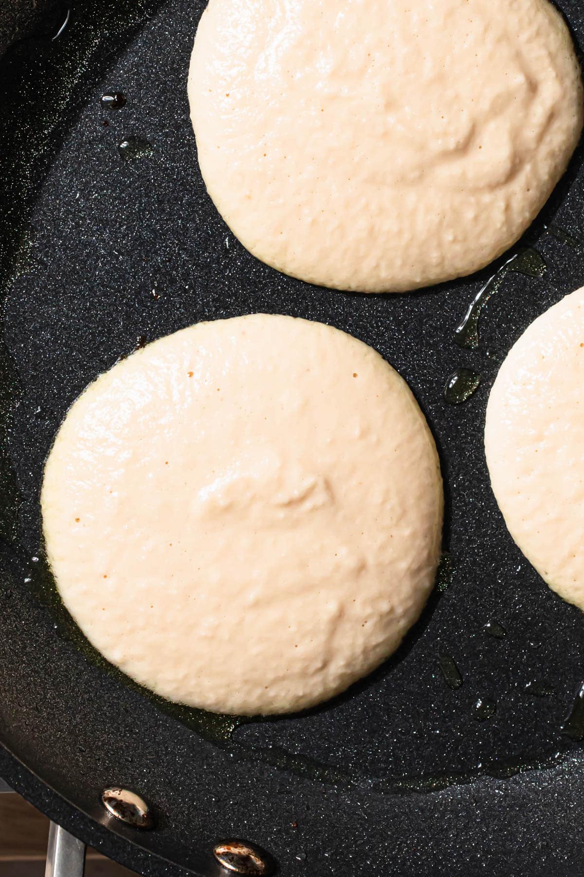 Gluten free pancake batter in a frypan.
