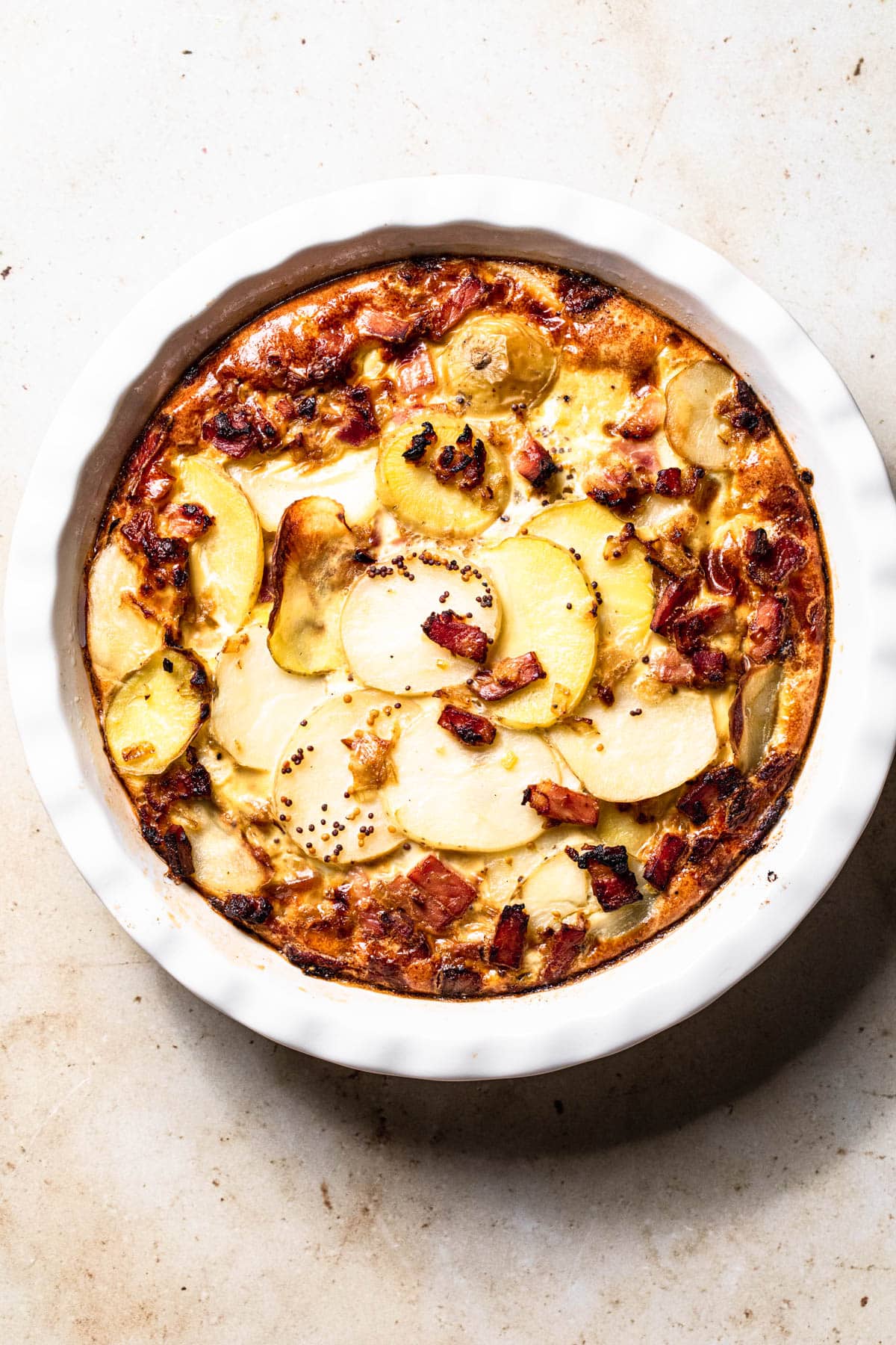 Dairy free frittata with potato and bacon in a quiche dish.