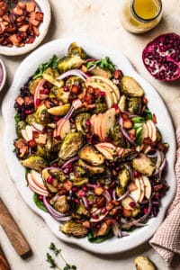Roasted Brussels sprouts salad with bacon, displayed on a serving platter.