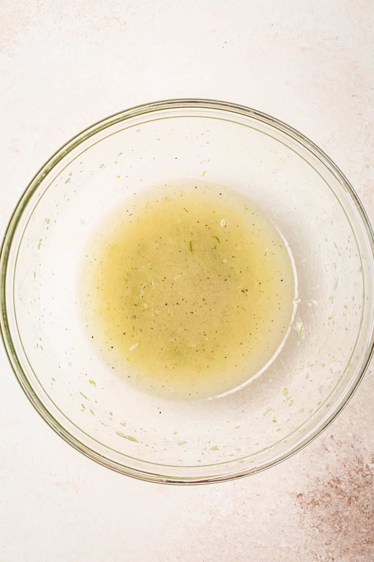 Honey lime vinaigrette mixed together in a medium glass bowl.