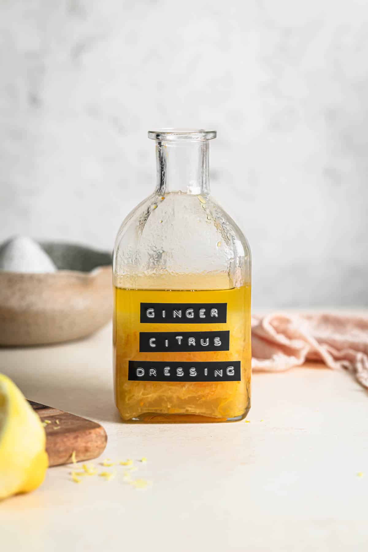 Ginger citrus dressing in a glass jar, labelled "Ginger Citrus Dressing".