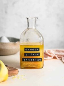 Ginger citrus dressing in a glass jar, labelled "Ginger Citrus Dressing".