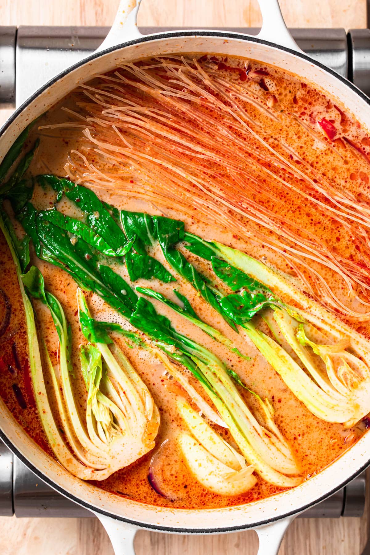 Noodles and halved bok chop added to vegetarian Thai noodle soup.