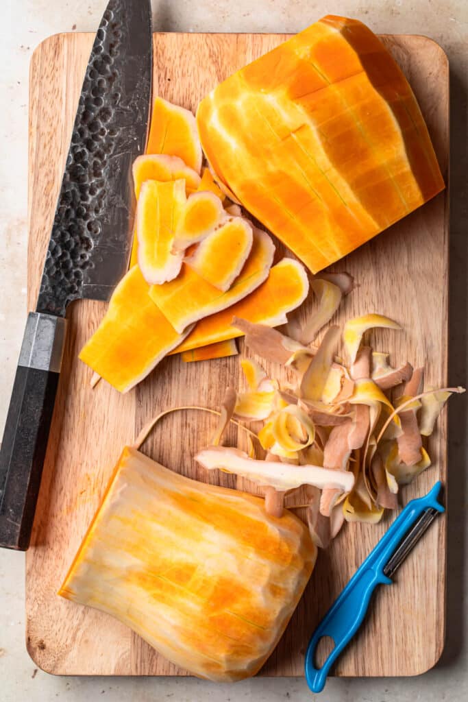 Skin removed from butternut squash using a vegetable peeler.