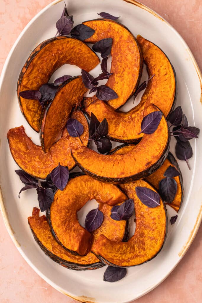 Maple roasted pumpkin wedges topped with purple basil.