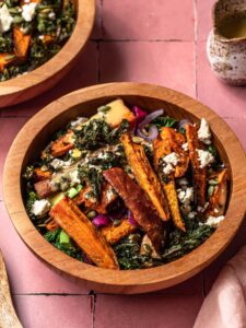 Roasted kale and sweet potato salad in a timber bowl.