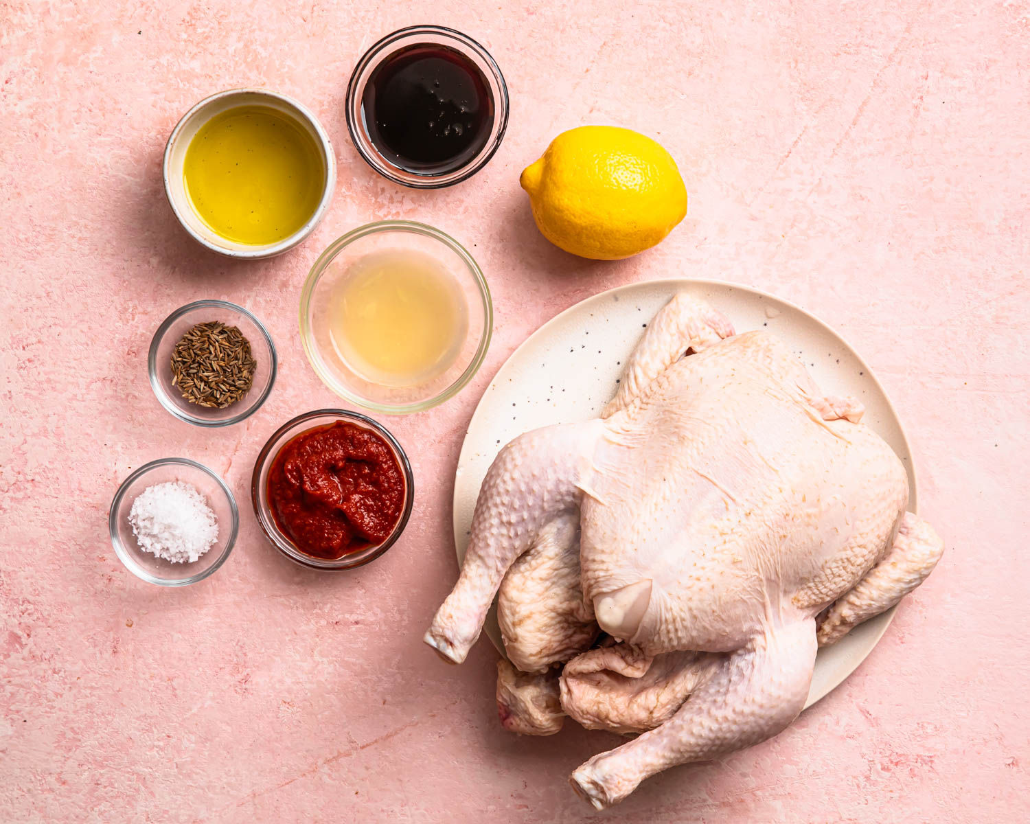 Ingredients for harissa roast chicken laid out in individual bowls. 