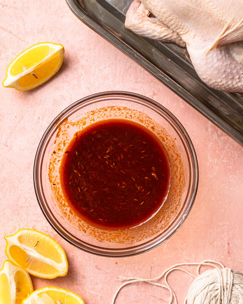 Harissa marinade whisked together in a glass bowl.