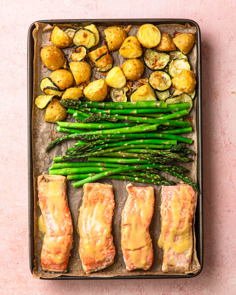 Cooked sheet pan salmon and asparagus with parmesan roasted potatoes. 