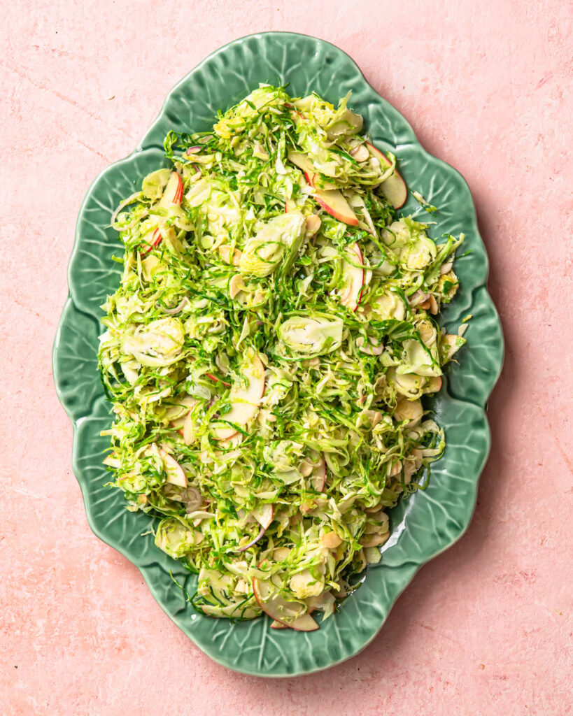 Shaved brussels sprout salad on a serving platter. 