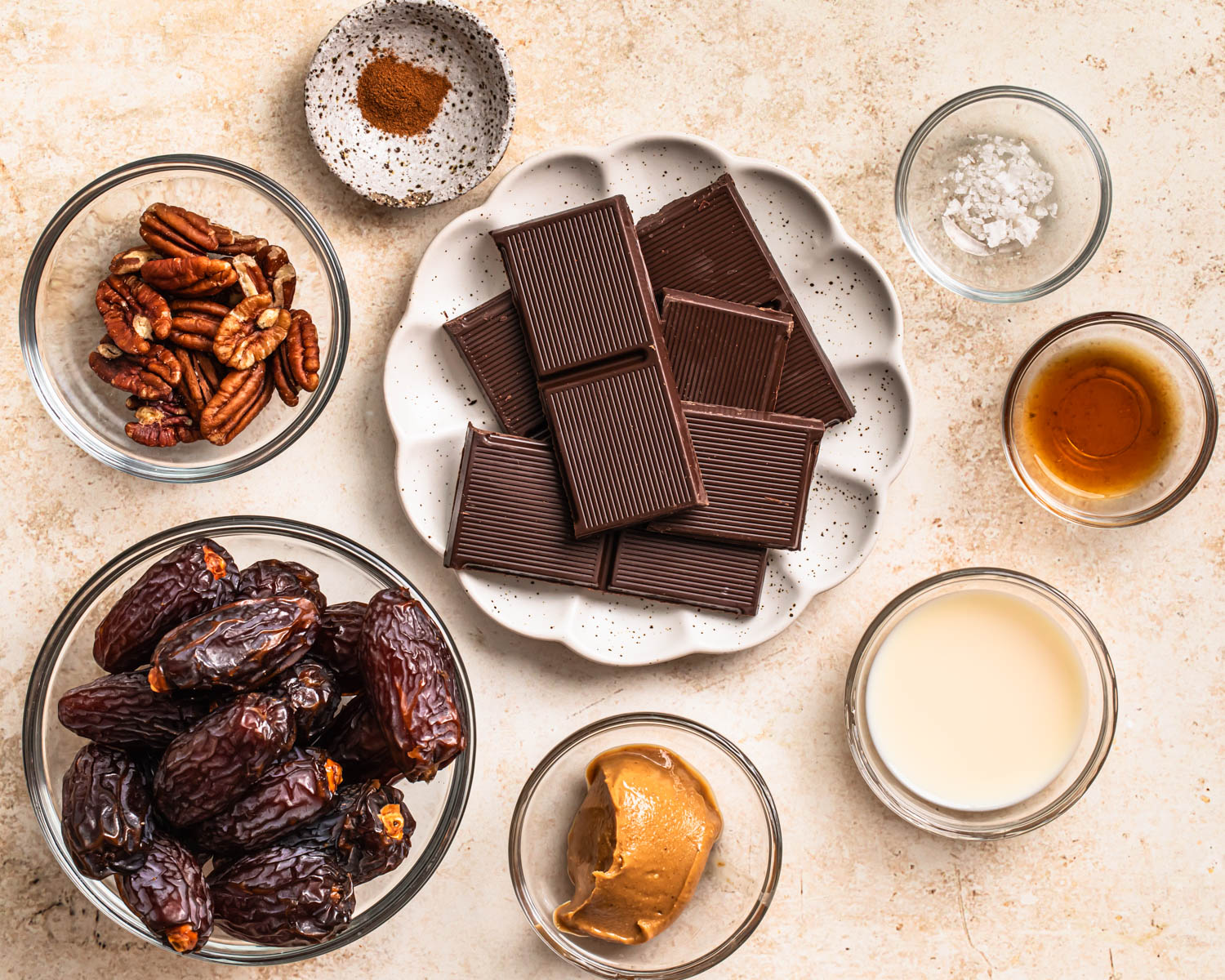 Ingredients to make pecan pie stuffed dates laid out in individual bowls.