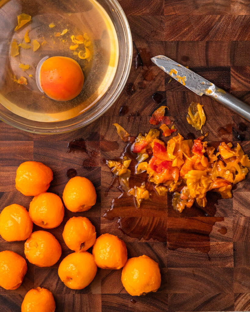 Peeled apricots on a wooden board. 