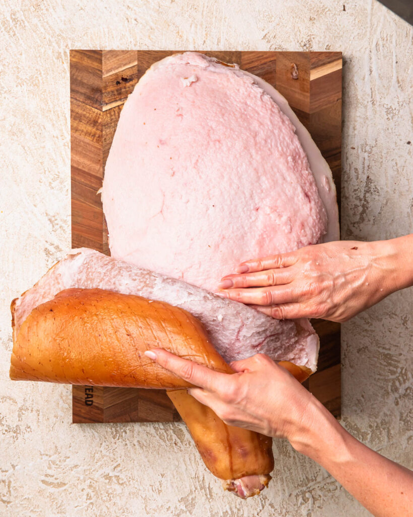 Two hands peeling the skin of a leg home. 