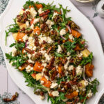 Butternut squash and feta salad topped with feta and candied pecans.