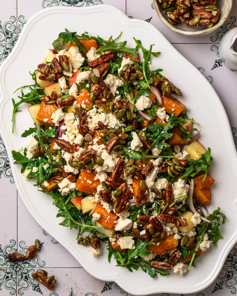 Butternut squash and feta salad topped with feta and candied pecans.