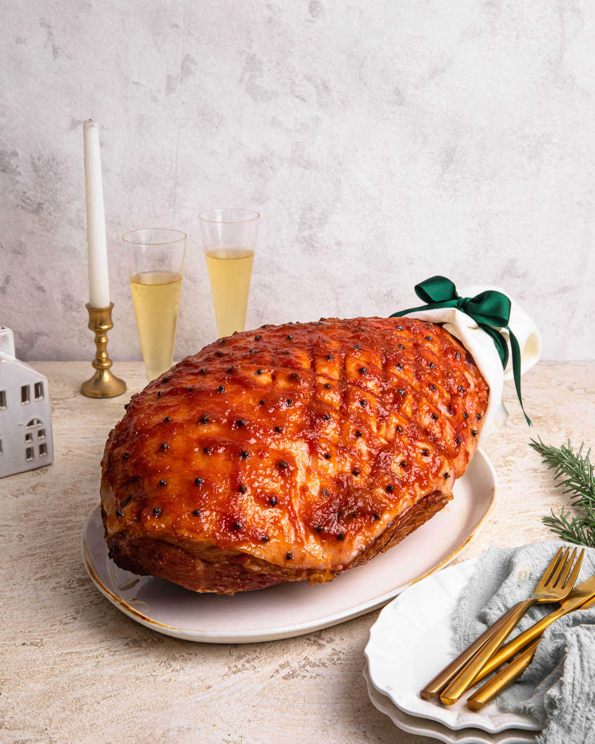 Spiced whiskey and apricot glazed ham on a serving platter.