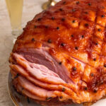 Close up of baked and sliced apricot glazed ham.