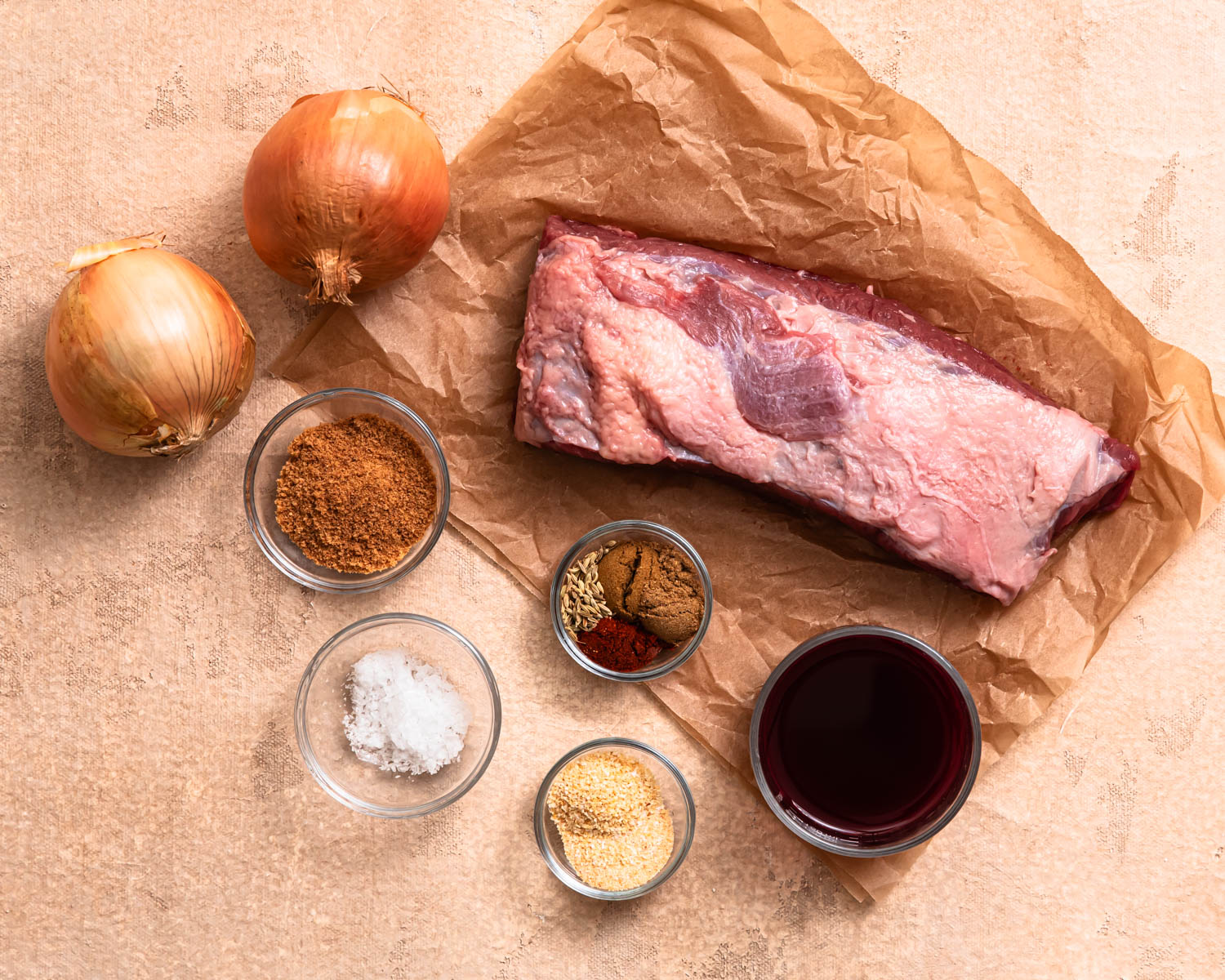Ingredients for pulled beef brisket laid out in individual bowls. 