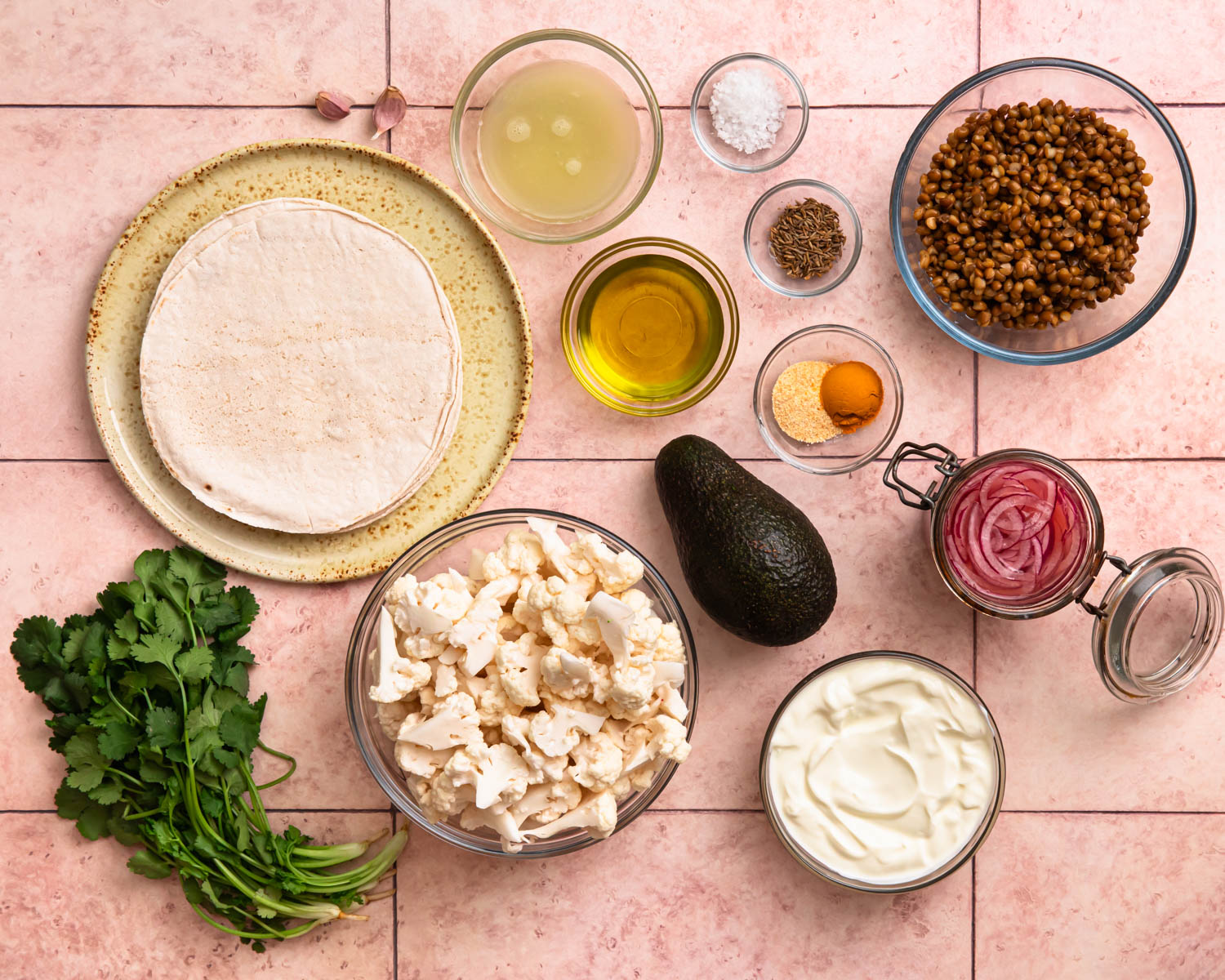 Ingredients for cauliflower lentil tacos laid out in individual bowls. 