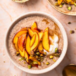 Chia and flaxseed pudding topped with peaches, yoghurt and crushed pistachios.