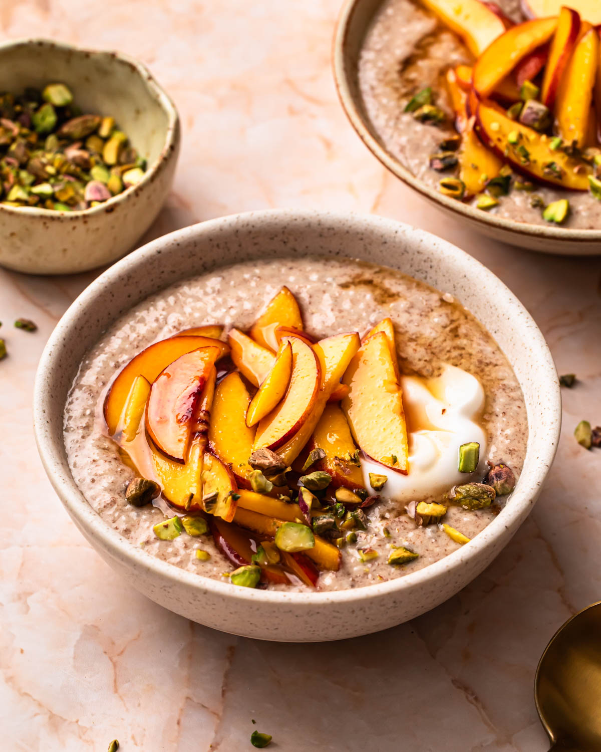 Chia and flaxseed pudding topped with peaches, yoghurt and crushed pistachios.