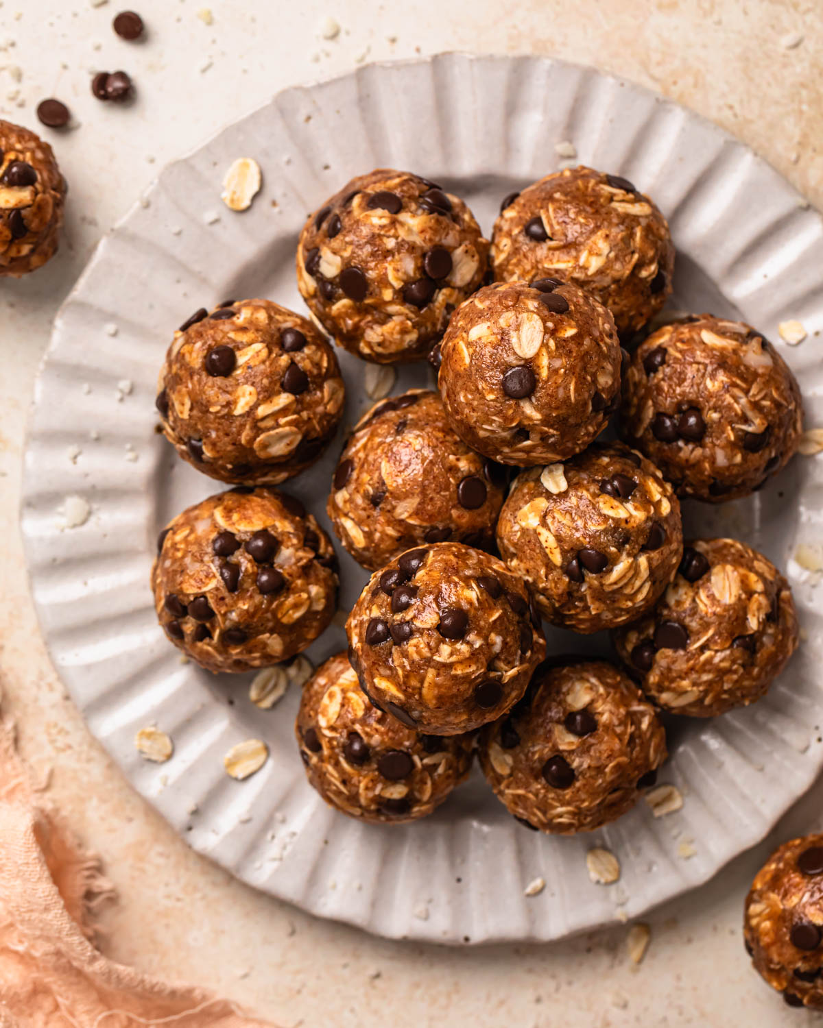 Choc chip oat energy balls arranged on a plate.