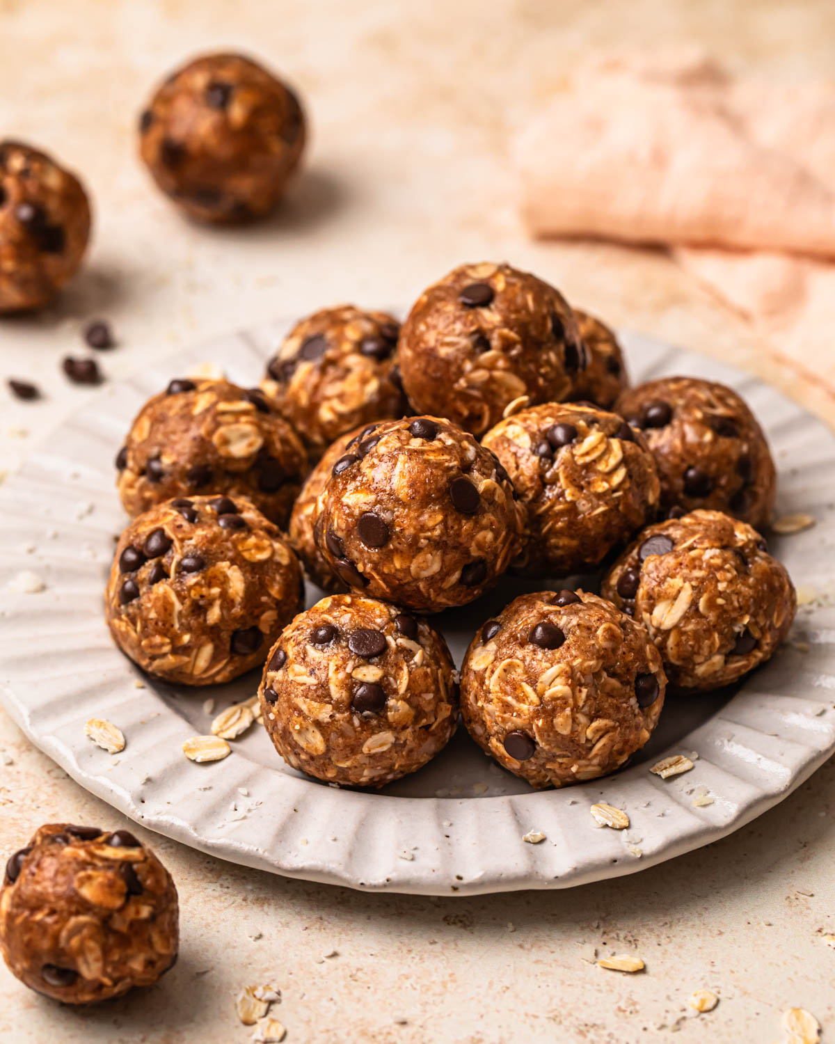 Choc chip oat energy balls arranged on a plate.