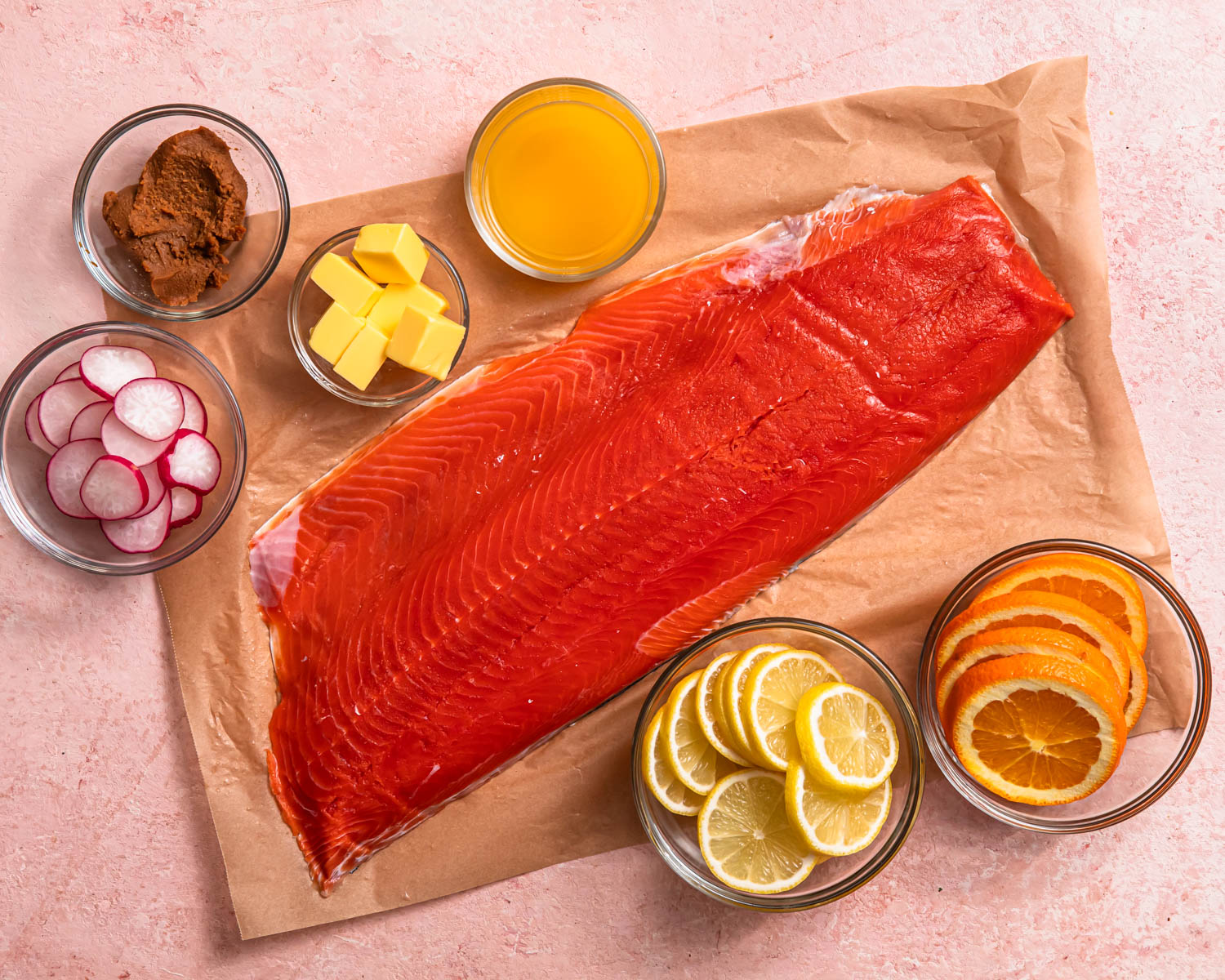 Ingredients for miso butter salmon laid out in individual dishes. 