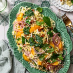Citrus slaw arranged on a green platter.