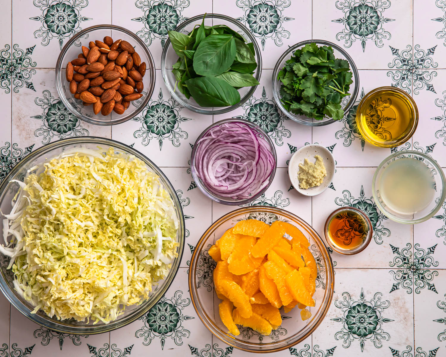 Ingredients for citrus slaw laid out in individual bowls. 