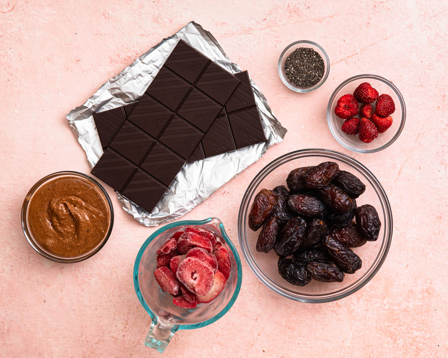 Ingredients for date bark laid out in individual bowls. 