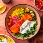 An image of an harissa honey salmon and rice bowl.