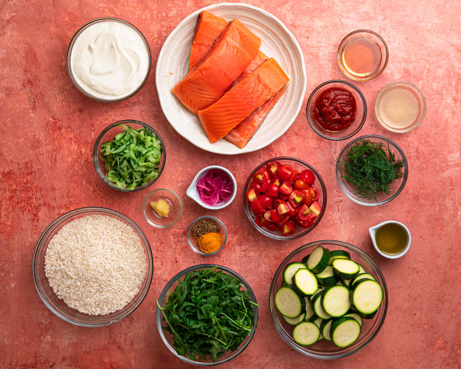 All ingredients for harissa honey salmon rice bowls laid out in individual bowls. 