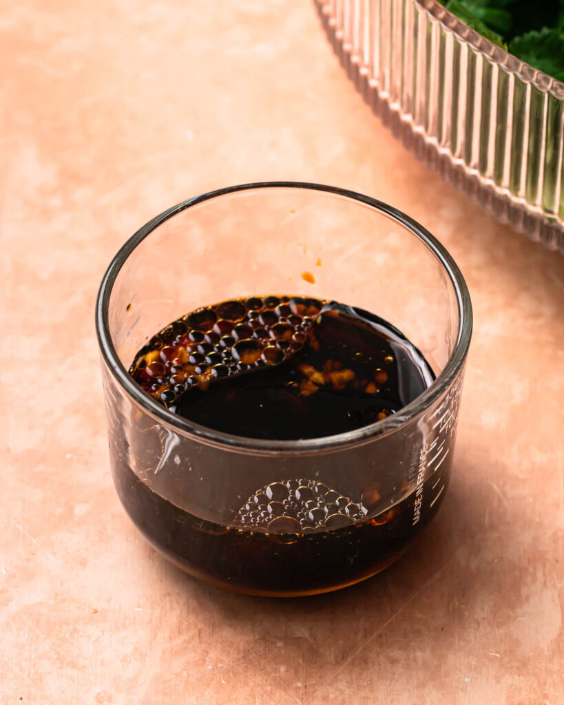 Dressing ingredients in a glass jar. 