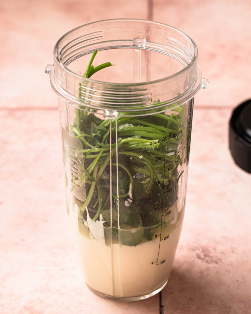 Ingredients for a cilantro lime yoghurt sauce in a blender. 