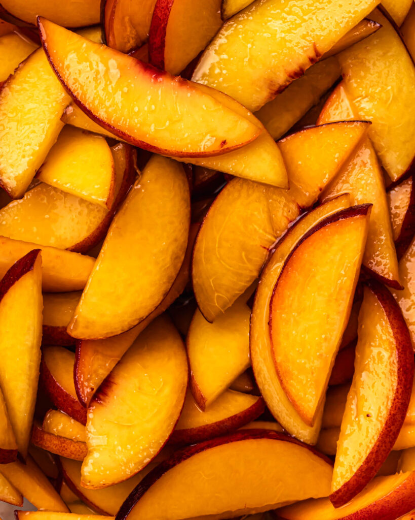 Close up of macerated peach slices.