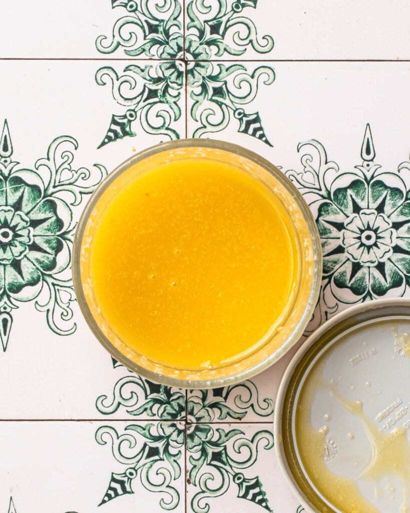 Lemon dressing for citrus slaw in a glass jar.