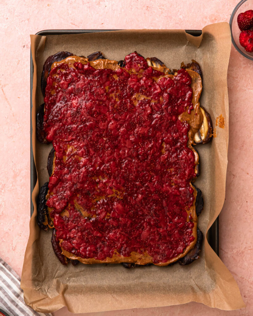 Strawberry chia jam spread over a layer of almond butter and medjool dates. 